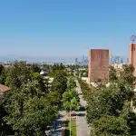 A scenic view of the USC campus with tree-lined walkways and iconic buildings under a clear sky, representing key details about the USC application deadline.