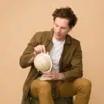 a student holding a tiny globe looking for the best international universities for American students