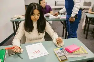 Student receiving her test paper, increasing her class rank