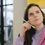 student in gray sweatshirt thinking about the brown gpa requirements