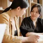 two students discussing about the pomona college sat requirements