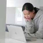 A young woman researching Amherst vs Swarthmore.