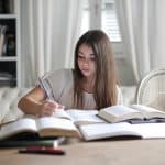 A female student writing UMich supplemental essays