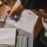 student drawing on a table for the architecture internships for high school students