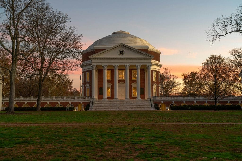 The Rotunda at the University of Virginia campus at sunset, with columns and fall trees in the foreground, representing UVA application deadline.
