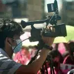 A high school student working for his school's campus journalism organization, which got recognized by Quill and Scroll.