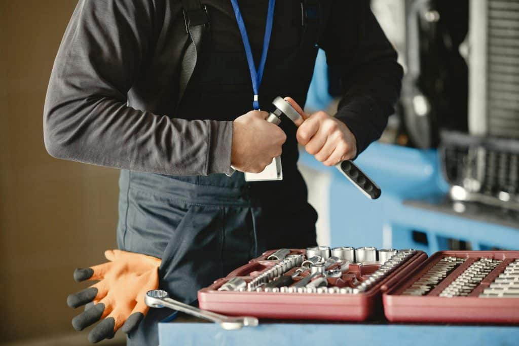 Engineering student using tools in a workshop setting, representing hands-on learning at the best colleges for mechanical engineering