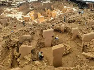 Archaeological excavation site with researchers uncovering ancient structures, representing field training at the best colleges for archaeology