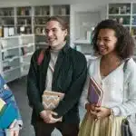 College students chatting in a campus library, representing a Georgia Tech vs Northwestern comparison in student life and academics