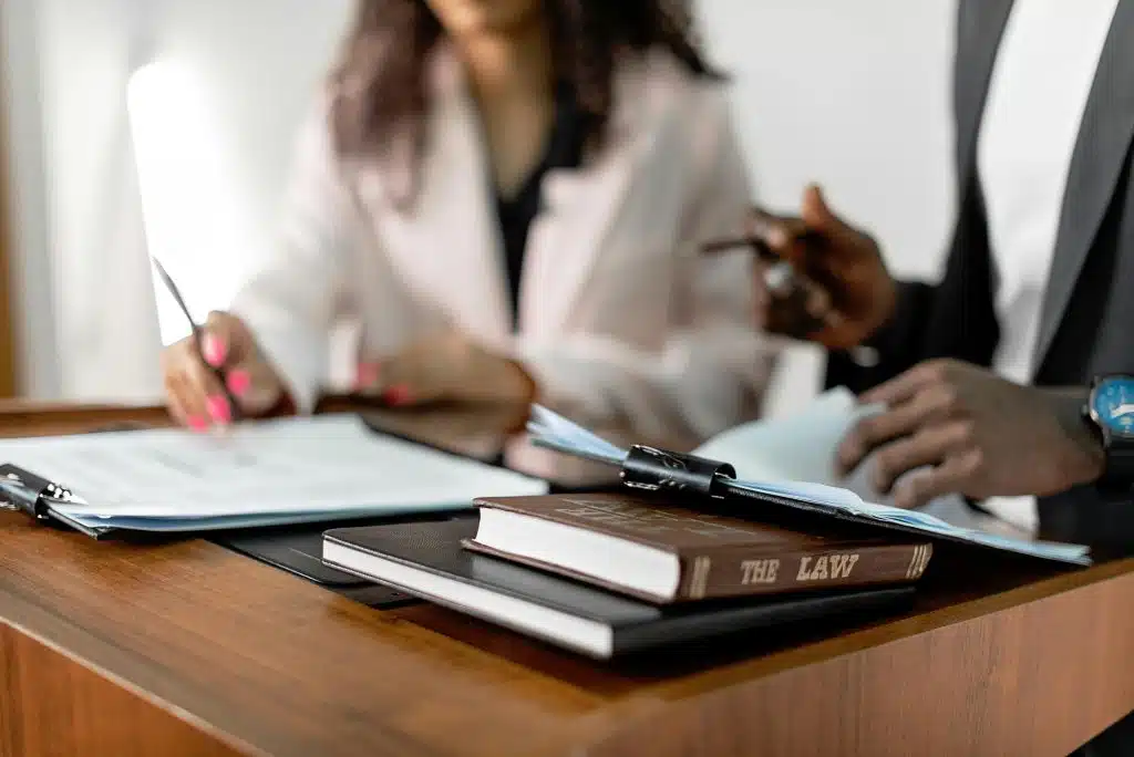 a table showing two person writing on a table for the tier 2 law schools