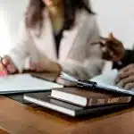 a table showing two person writing on a table for the tier 2 law schools