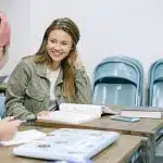 students in a classroom discussing about the carleton college acceptance rate