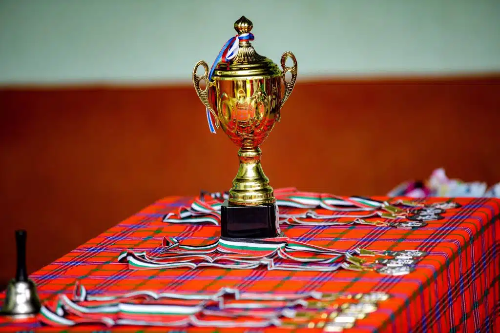 Gold trophy and medals on a table at competitions for high school students