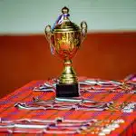 Gold trophy and medals on a table at competitions for high school students